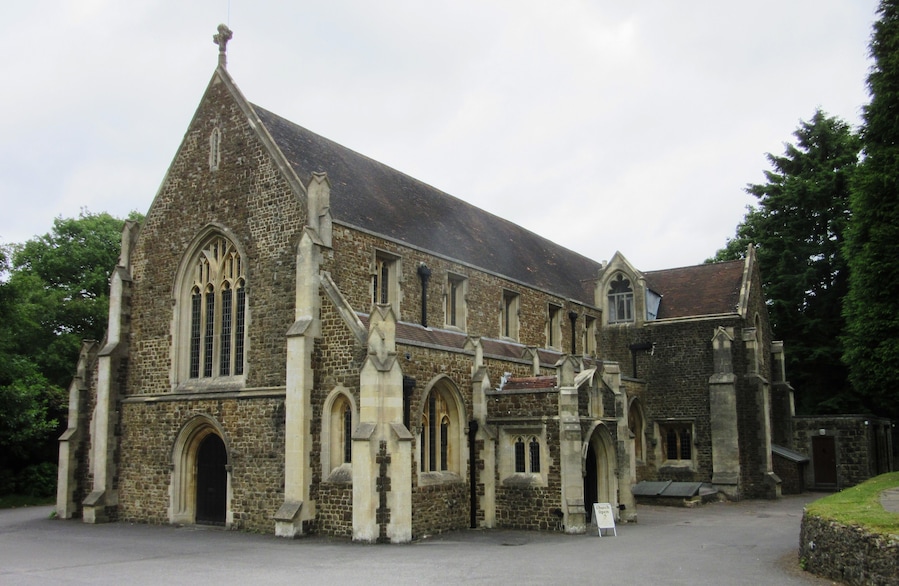 A historic stone church with pointed arches and a steeply pitched roof.