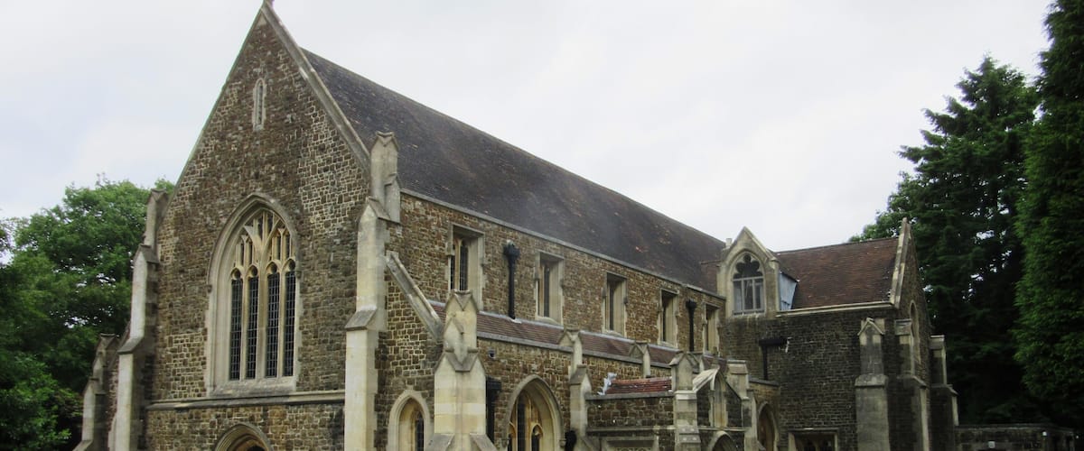 A historic stone church with pointed arches and a steeply pitched roof.