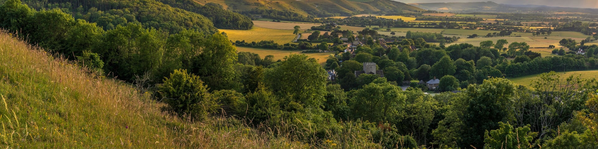 Beautiful views west over the village of Poynings from Devils Dyke to Chanctonbury ring on the south downs in west Sussex south east England UK