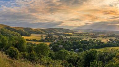 Beautiful views west over the village of Poynings from Devils Dyke to Chanctonbury ring on the south downs in west Sussex south east England UK