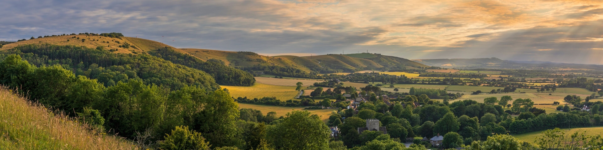 Rolling hills, a village, and a distant castle.