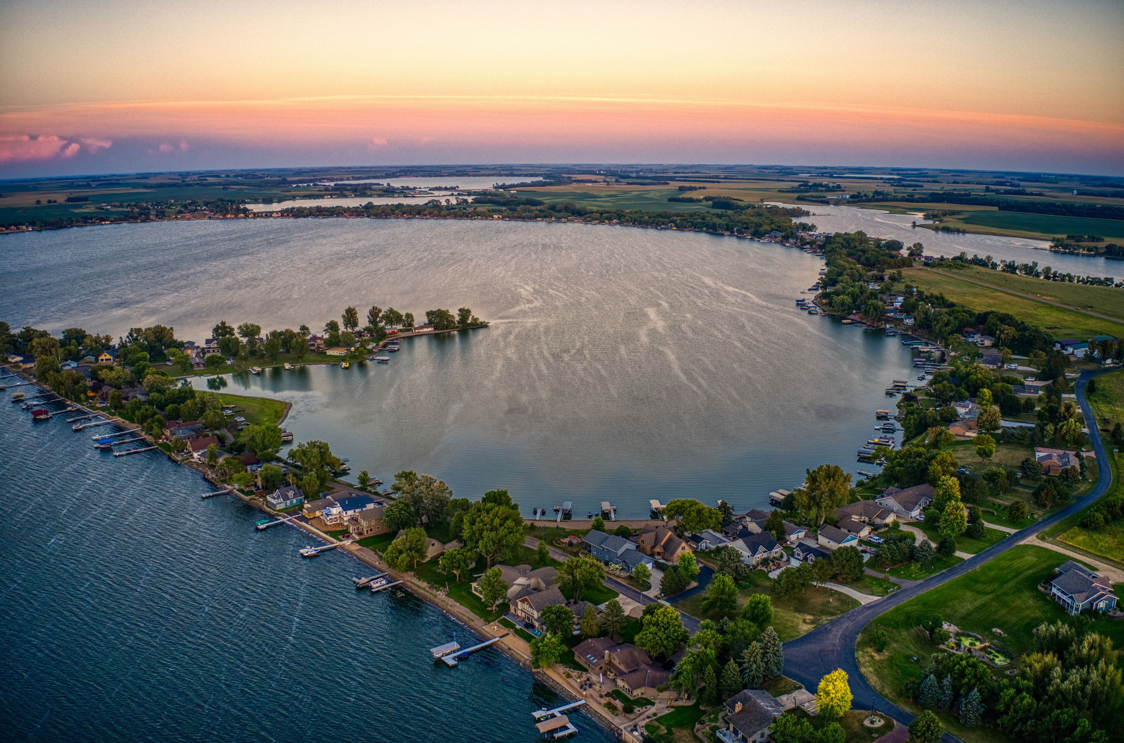 An aerial view of a lake surrounded by residential areas and docks.