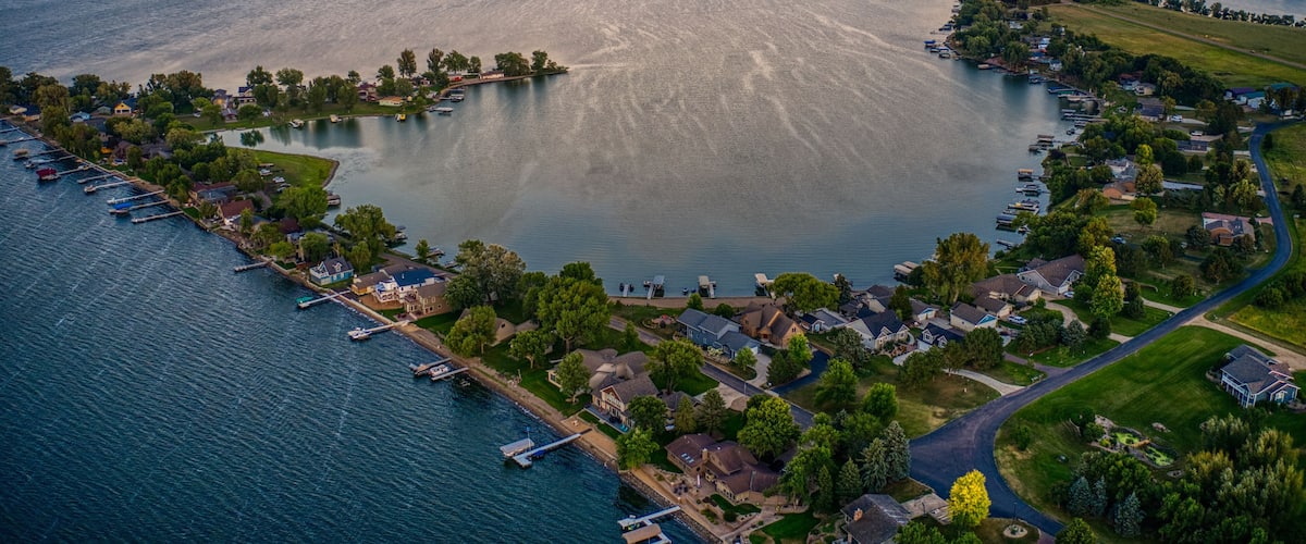 An aerial view of a lake surrounded by residential areas and docks.