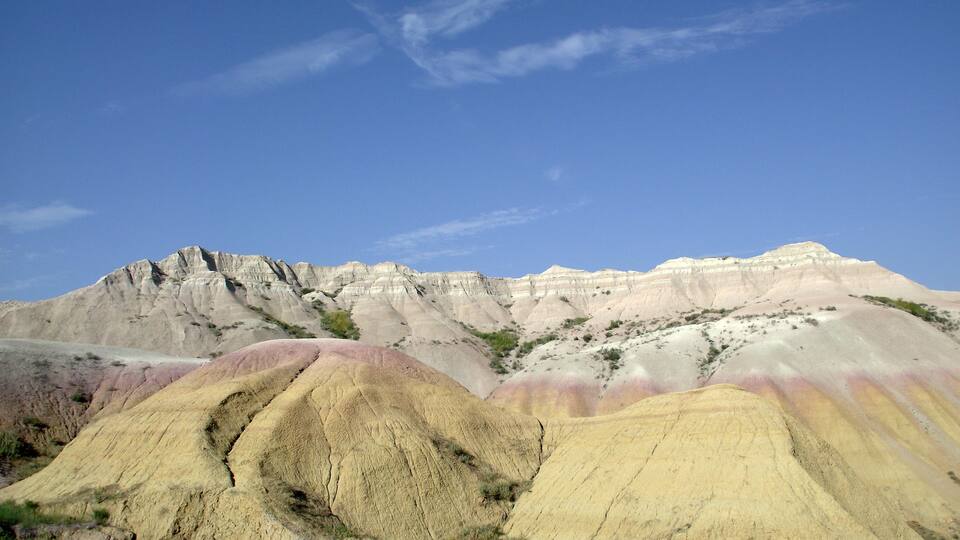 A colorful rock formation with layered sedimentary structures.