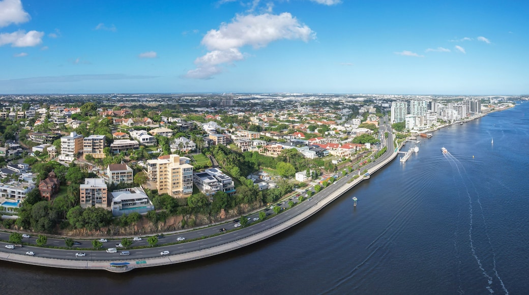 Aerial view of Portside Wharf along the Brisbane River with the Gateway Bridge and cityscape, Hamilton, Australia.