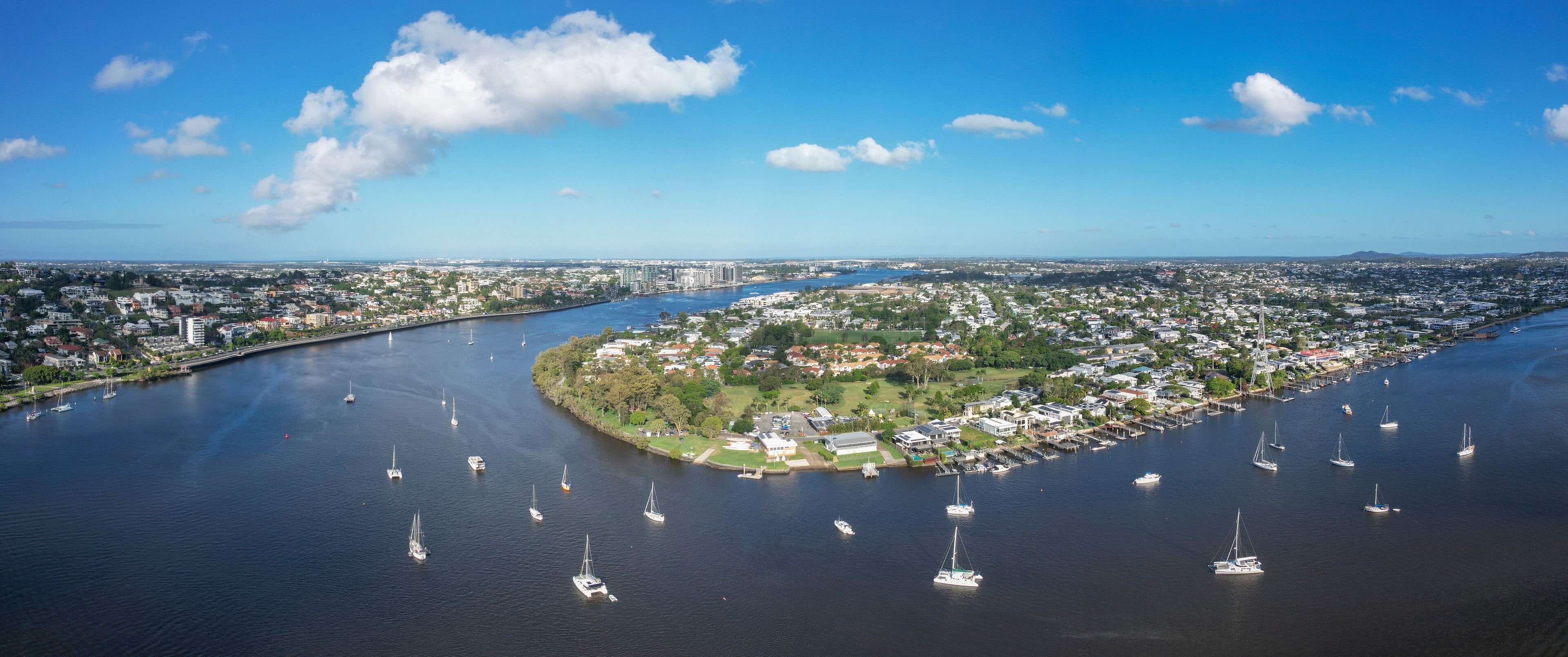 Aerial view of brisbane river with sailing boats and cityscape, bulimba, queensland, australia.
