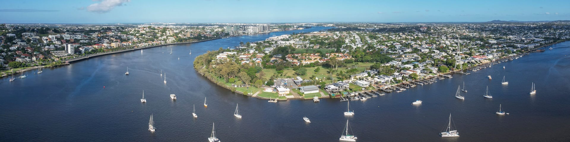 Aerial view of brisbane river with sailing boats and cityscape, bulimba, queensland, australia.