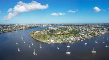 Aerial view of brisbane river with sailing boats and cityscape, bulimba, queensland, australia.