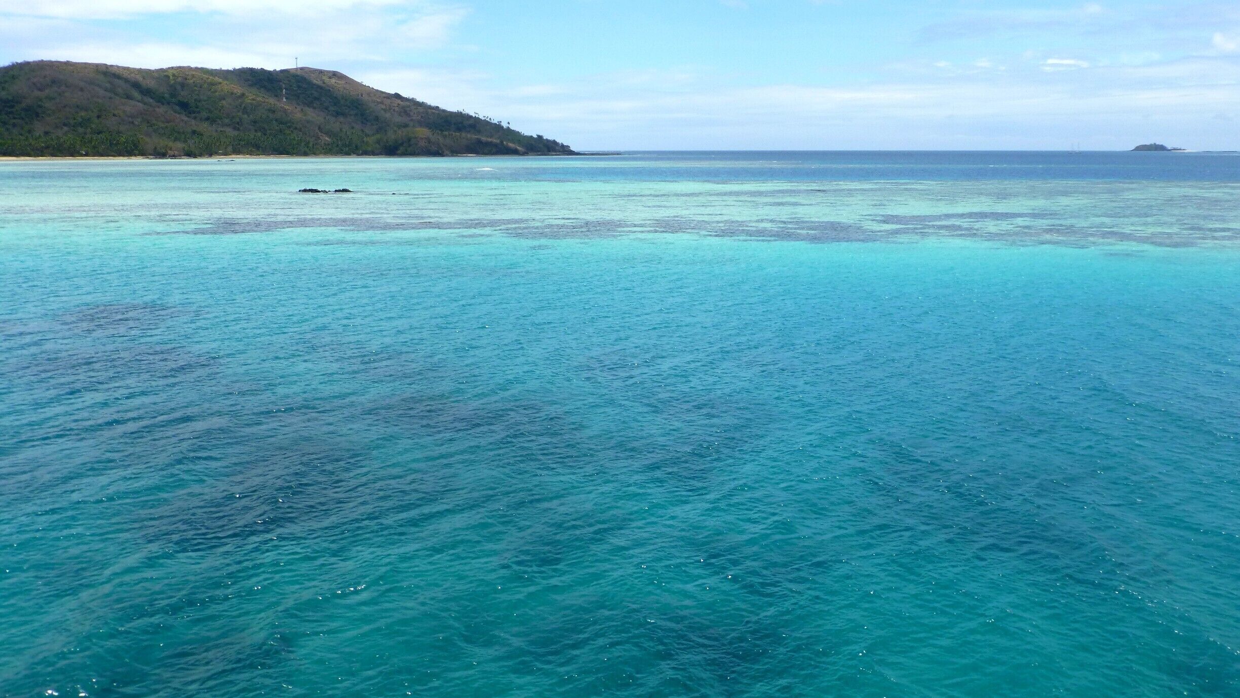 If you visit Fiji I would highly recommend taking the Yasawa Flyer to get a great view of the islands with this view as the creme de la creme where the flyer turns around and heads back past all the islands. A full day of sitting and relaxing on top of this boat. The colors of the water and the movement of the clouds is stunning.