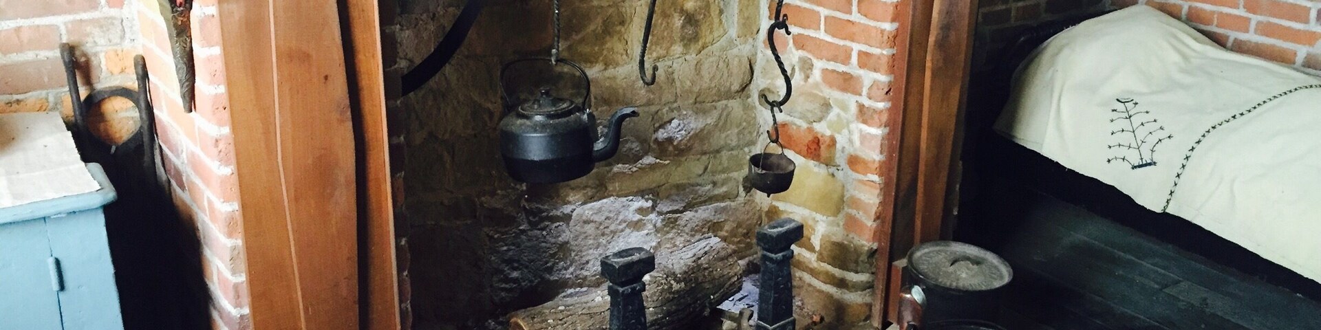 Inside the Prickett's family log home. Living quarters and kitchen all in one area which sheltered 16 children at one point in time.