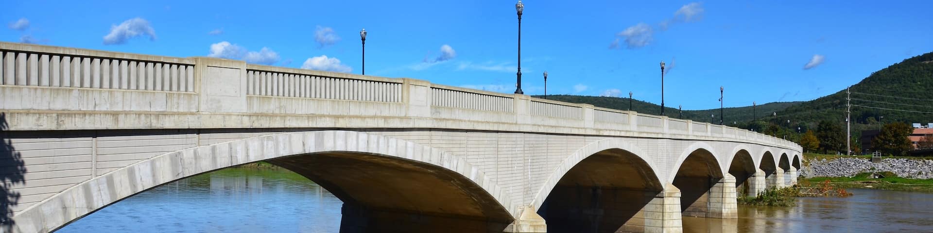CENTERWAY ARCH BRIDGE, in Corning, New York. Centerway Walking Bridge Earns National Recognition. Built in 1921, the 40-foot-wide, 710-foot-long; while the restoration completed in 2013. chemung river