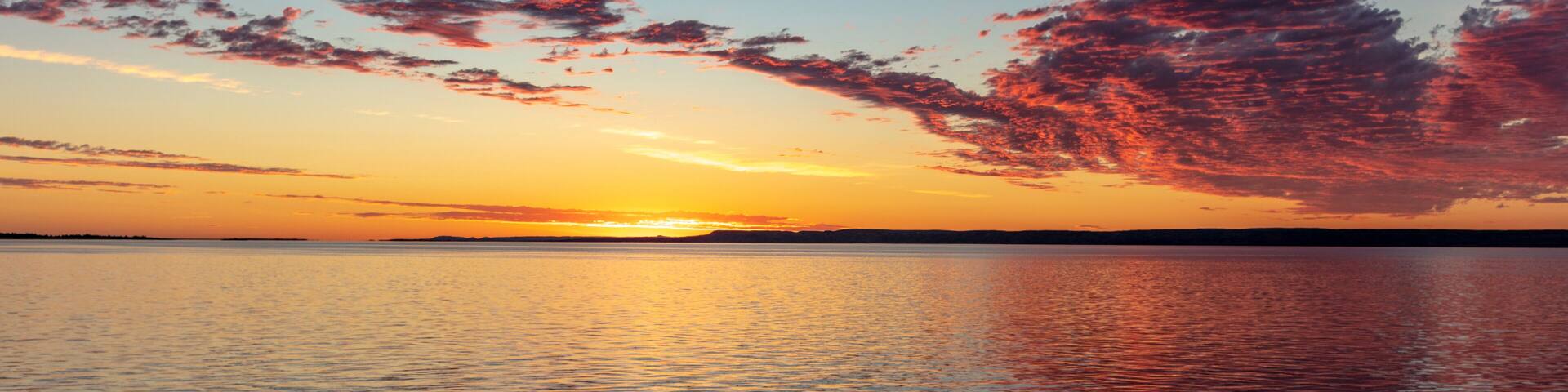 Vivid sunrise clouds over Fort Peck Reservoir in the Charles M Russell National Wildlife Refuge near Fort Peck, Montana, USA