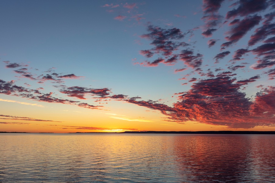 Vivid sunrise clouds over Fort Peck Reservoir in the Charles M Russell National Wildlife Refuge near Fort Peck, Montana, USA