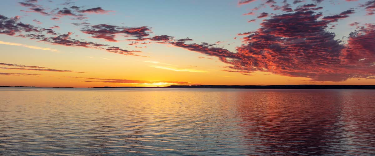 Vivid sunrise clouds over Fort Peck Reservoir in the Charles M Russell National Wildlife Refuge near Fort Peck, Montana, USA