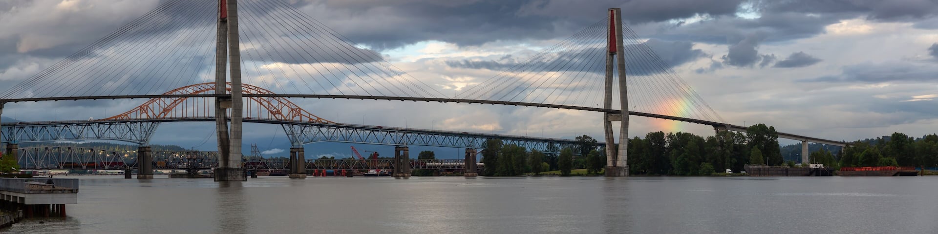Panoramic view of Skytrain Bridge and Pattullo Bridge during a stormy evening. Taken in New Westminster, Greater Vancouver, BC, Canada.