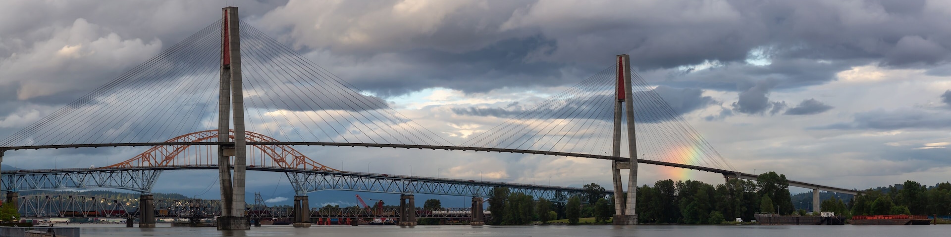Panoramic view of Skytrain Bridge and Pattullo Bridge during a stormy evening. Taken in New Westminster, Greater Vancouver, BC, Canada.