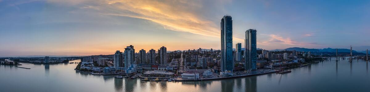 Modern City by river at sunset twilight. New Westminster, Vancouver, BC, Canada.