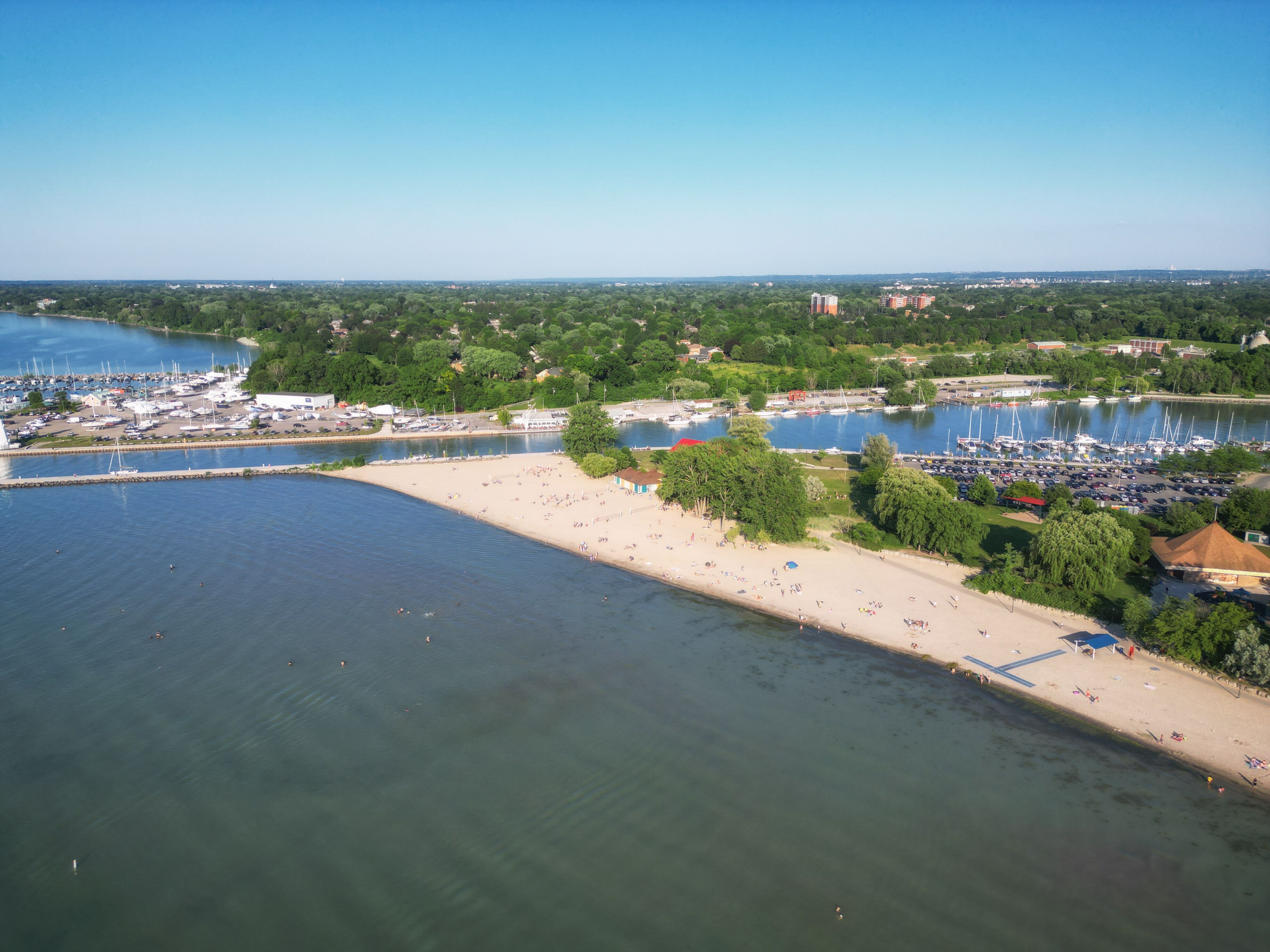 Aerial over Lakeside Park Beach in the Port Dalhousie area of St. Catharines, Ontario, Canada, on the south shore of Lake Ontario, with Martindale Pond. Shot on a summer afternoon in July, 2024.