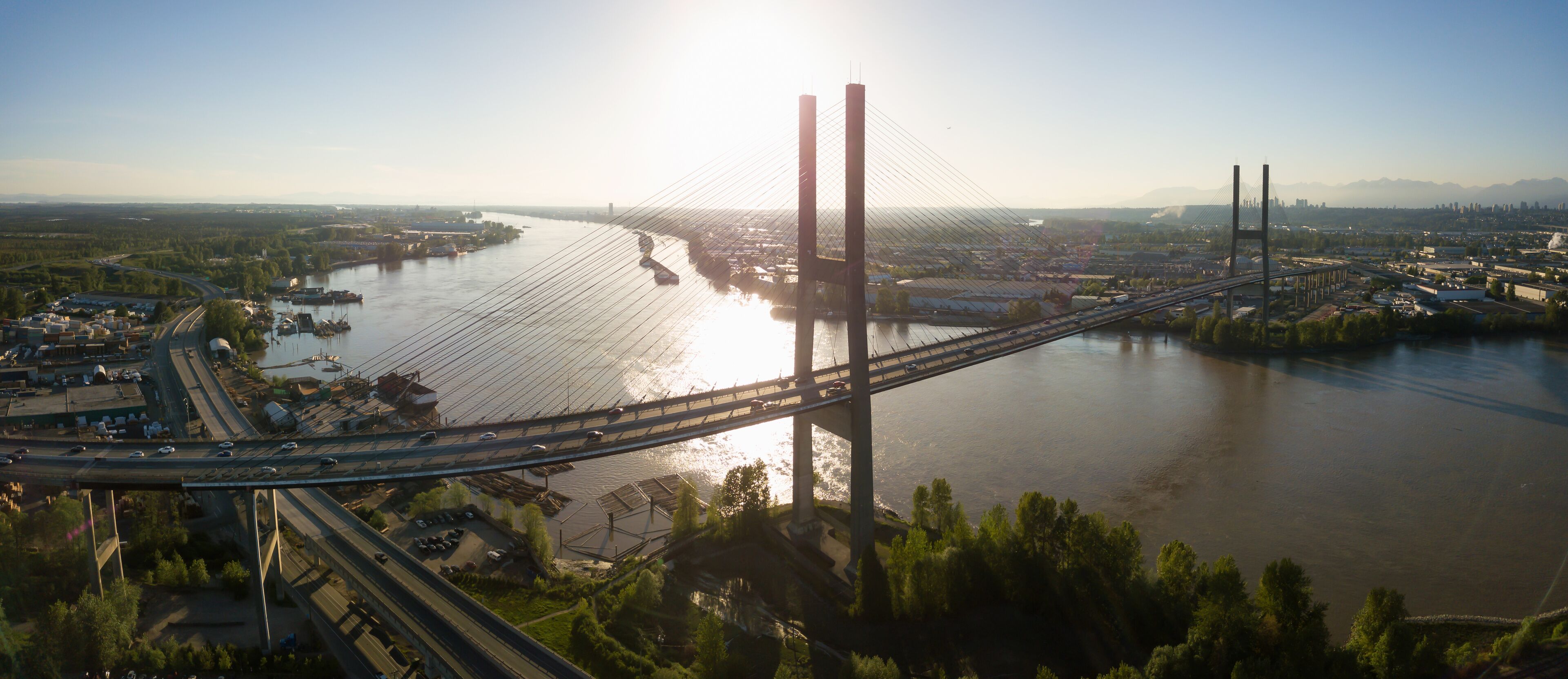 Aerial view of Alex Fraser Bridge during a vibrant sunny day. Taken in North Delta, Greater Vancouver, BC, Canada.