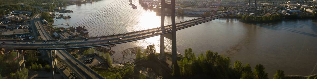 Aerial view of Alex Fraser Bridge during a vibrant sunny day. Taken in North Delta, Greater Vancouver, BC, Canada.