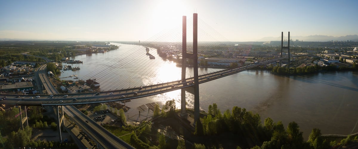 Aerial view of Alex Fraser Bridge during a vibrant sunny day. Taken in North Delta, Greater Vancouver, BC, Canada.