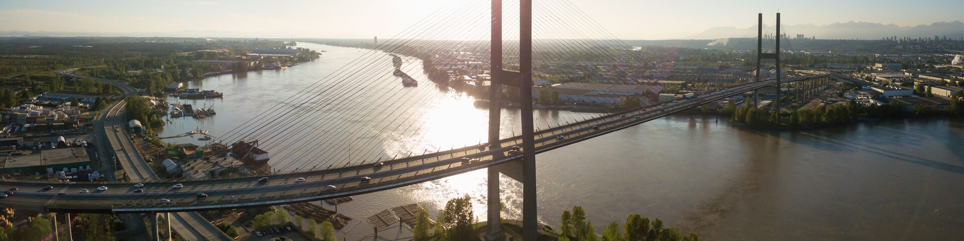 Aerial view of Alex Fraser Bridge during a vibrant sunny day. Taken in North Delta, Greater Vancouver, BC, Canada.