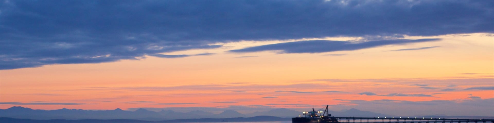 Delta featuring general coastal views and a sunset