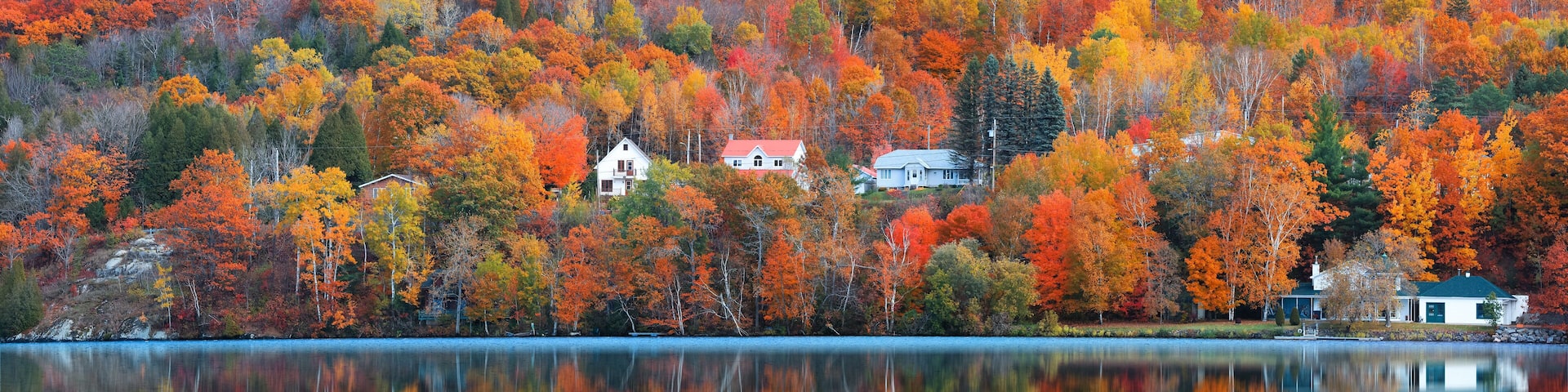 Panoramic view of Saint-Jean-des-Piles village surrounded with bright fall foliage in Quebec, Canada
