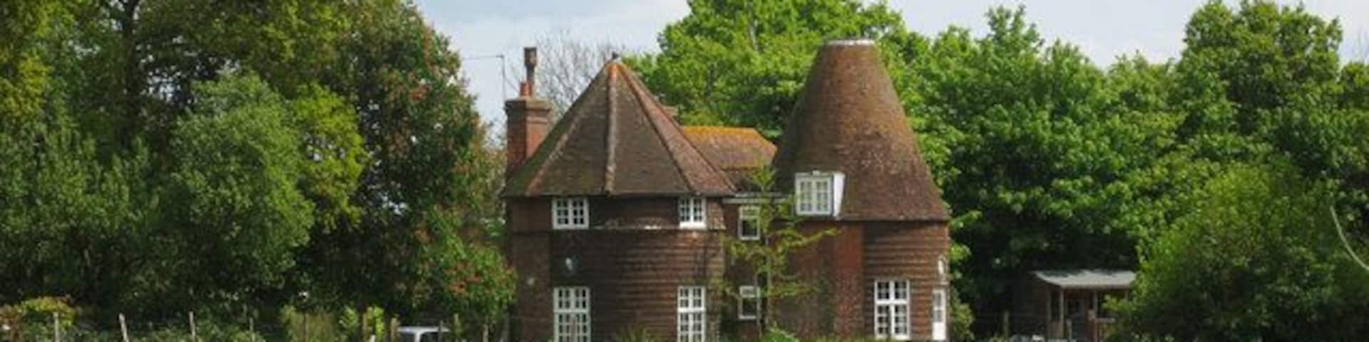 Oast House at Pekes, Nash Street, Golden Cross, East Sussex Twin round kiln oast house, one kiln now has an eight sided roof, the other missing its cowl. Keywords: roundel, converted, flat roof dormer, tile hanging, chimney, cowl-less
