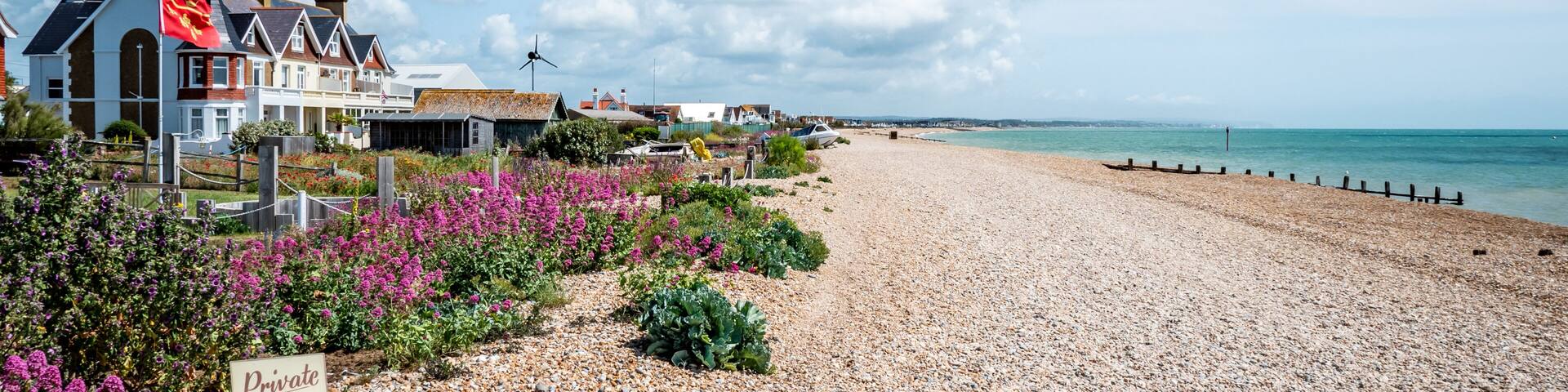 Pevensey Bay, East Sussex, England. Typical beach front houses along the coastline of a pebble beach on the south coast of England.