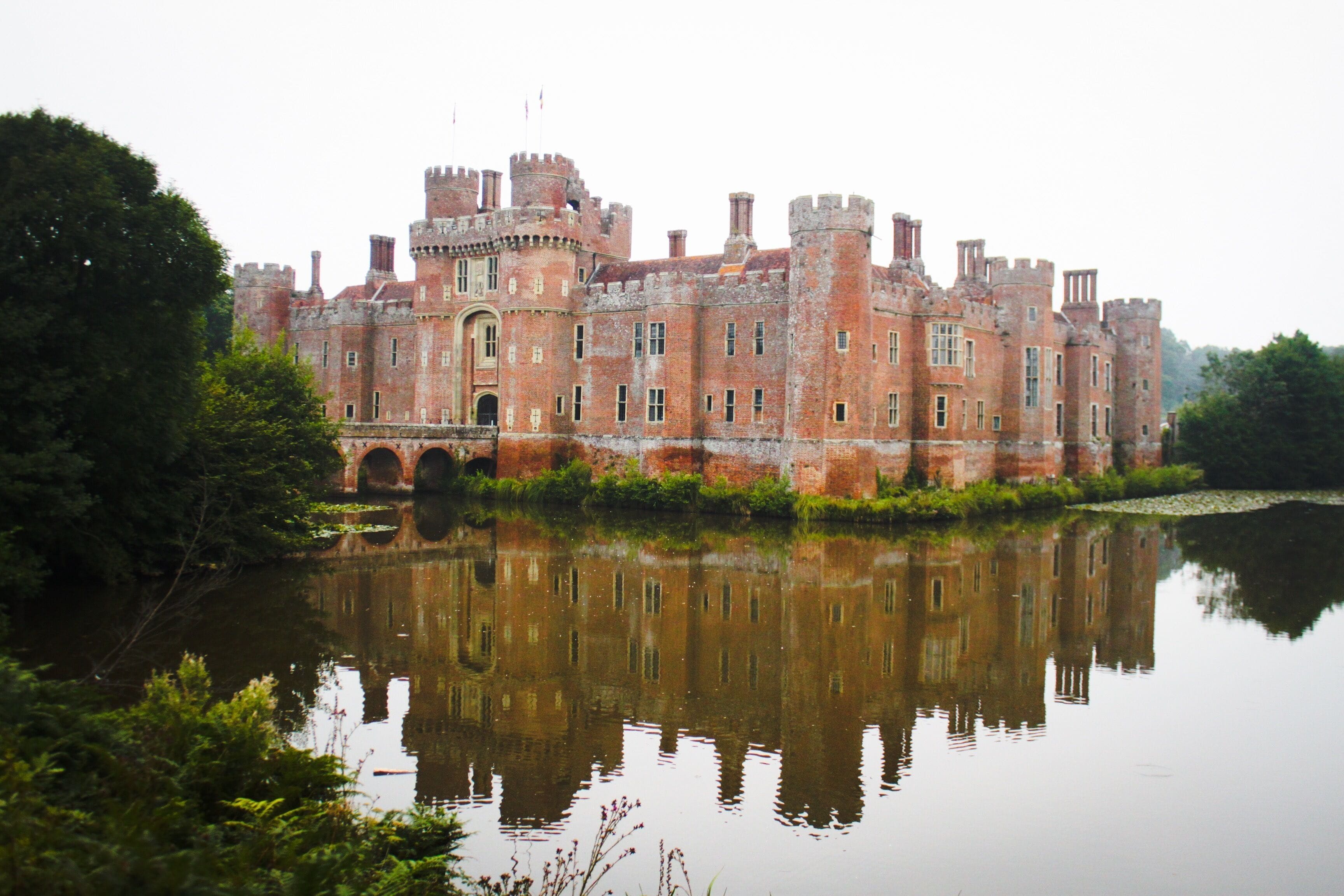 HERSTMONCEUX CASTLE WITH ATTACHED BRIDGES TO NORTH AND SOUTH AND CAUSEWAY WITH MOAT RETAINING WALLS TO WEST Wikidata has entry Q2652207 with data related to this building.