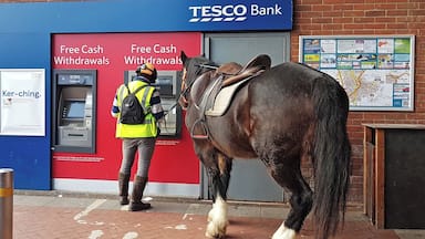 Not a sight you see every day and I wouldn't usually post a photo of a person at a cashpoint machine!
However, this guy in Hailsham, East Sussex just rode up on his horse, jumped off and got his cash. Looks like the horse knows his pin number now!