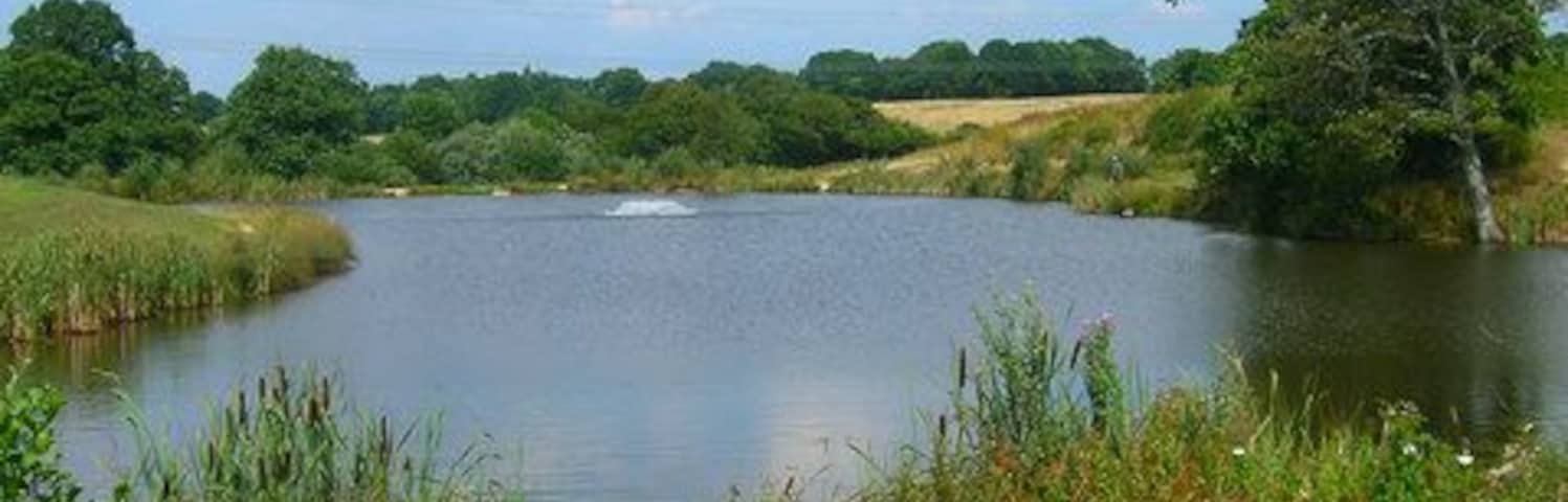 Brick Farm Lakes Trout fishery near Windmill Hill. There are currently two lakes though only one marked on the map which is this one. See http://www.brickfarmlakes.co.uk/ . Taken from the footpath that links Herstmonceux village to Nunningham Bridge
