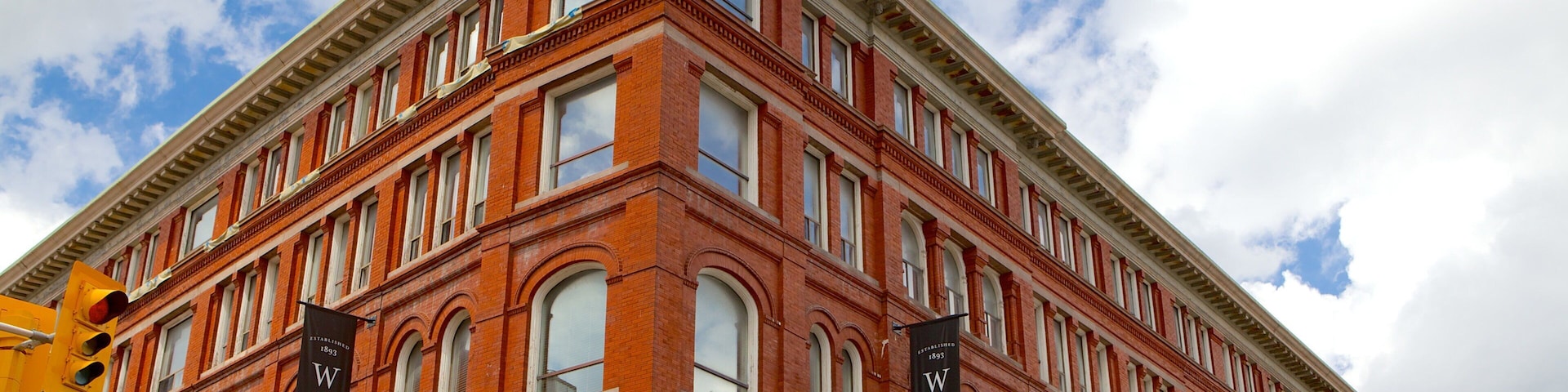 A historic red brick building with a sign reading "The Palmer Terrace Hotel."