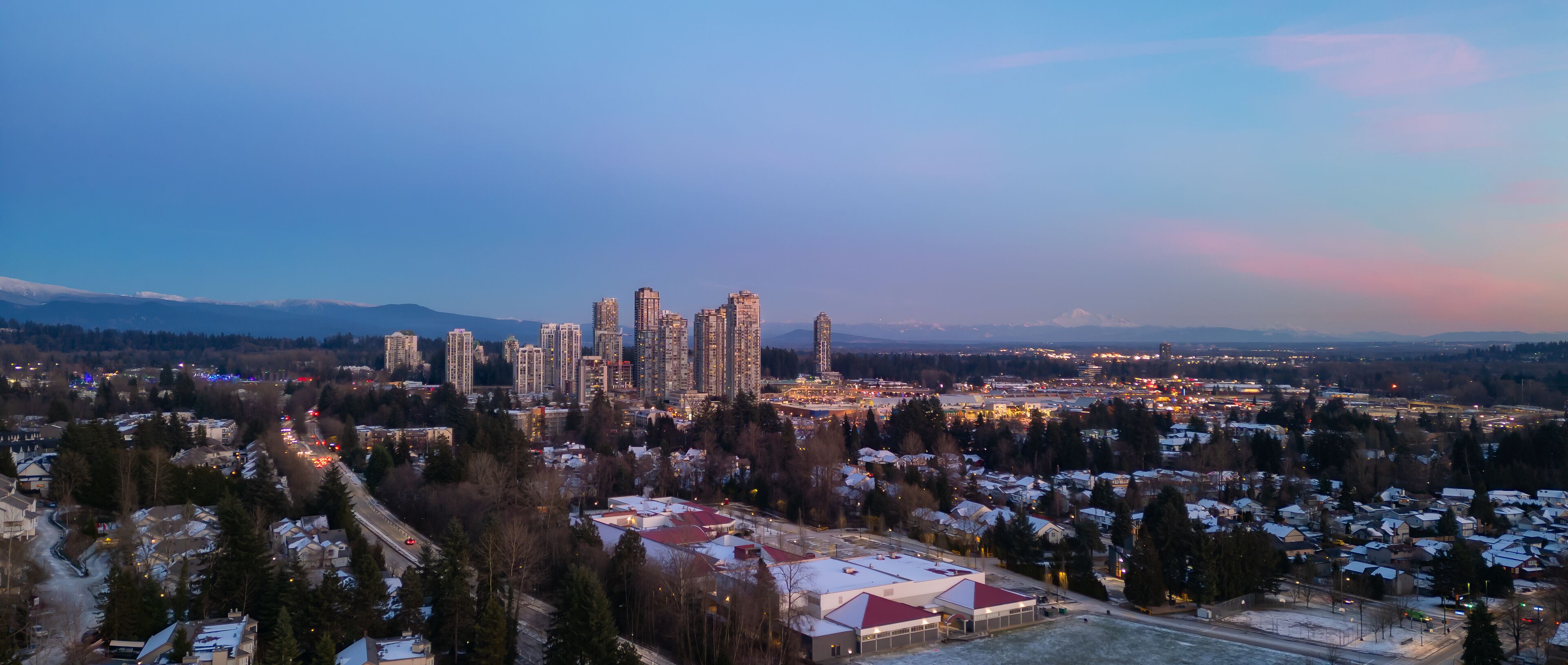 Buildings and Residential Homes near Town Centre. Aerial City Sunset.