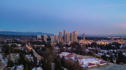 Buildings and Residential Homes near Town Centre. Aerial City Sunset.