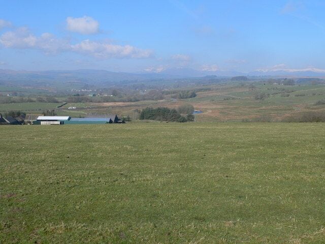 Over the field to Cae Gwyn In the far distance, the mountains of Snowdonia can be seen with a sprinkling of snow on the top.