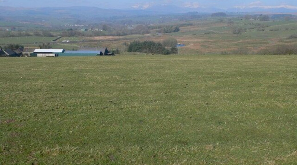 Over the field to Cae Gwyn In the far distance, the mountains of Snowdonia can be seen with a sprinkling of snow on the top.