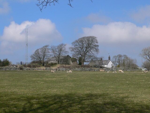 Old and new A modern communications mast alongside an old farm; Plas Iolyn was the home in Tudor times of the Prys family.
