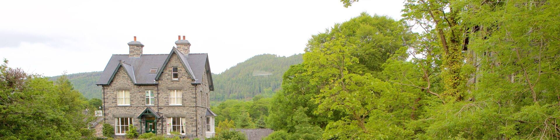 Betws-Y-Coed which includes forest scenes, a house and a river or creek