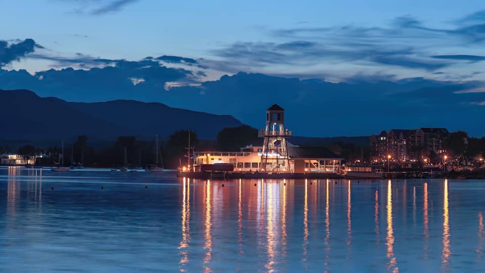 Magog harbor dock and lighthouse at night Memphremagog lake sunset light water and sky