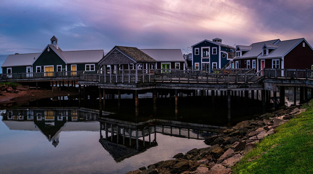 Summerside Harbour Sunset Seascape with rustic cape style houses and stores, and water reflections at twilight hour in Gulf of St Lawrence, Prince Edward Island, Canada
