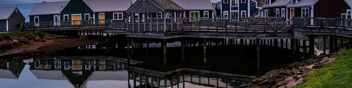 Summerside Harbour Sunset Seascape with rustic cape style houses and stores, and water reflections at twilight hour in Gulf of St Lawrence, Prince Edward Island, Canada