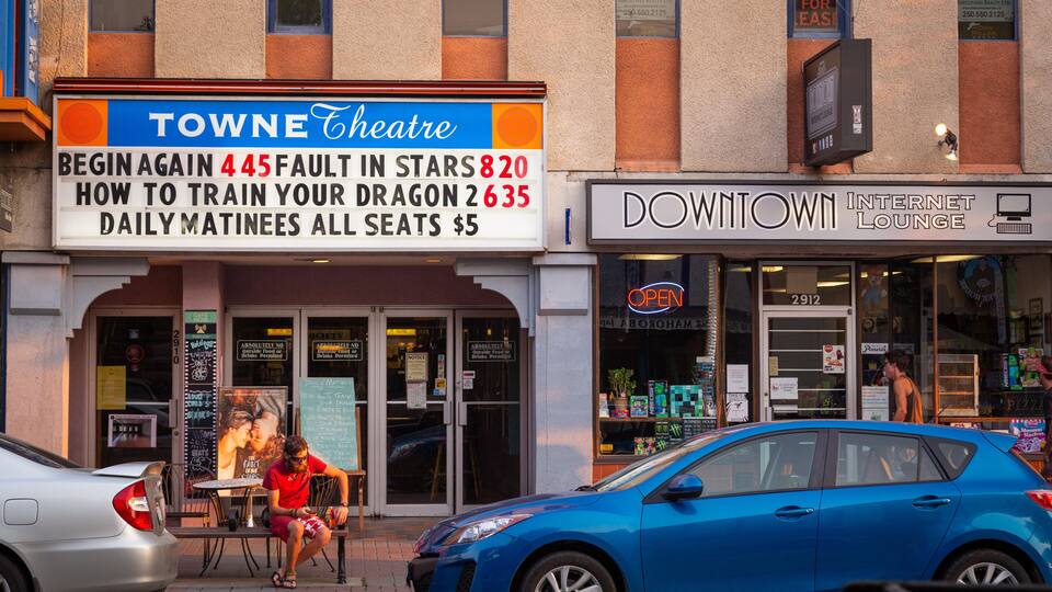 Towne Theatre with a sign advertising matinee shows.