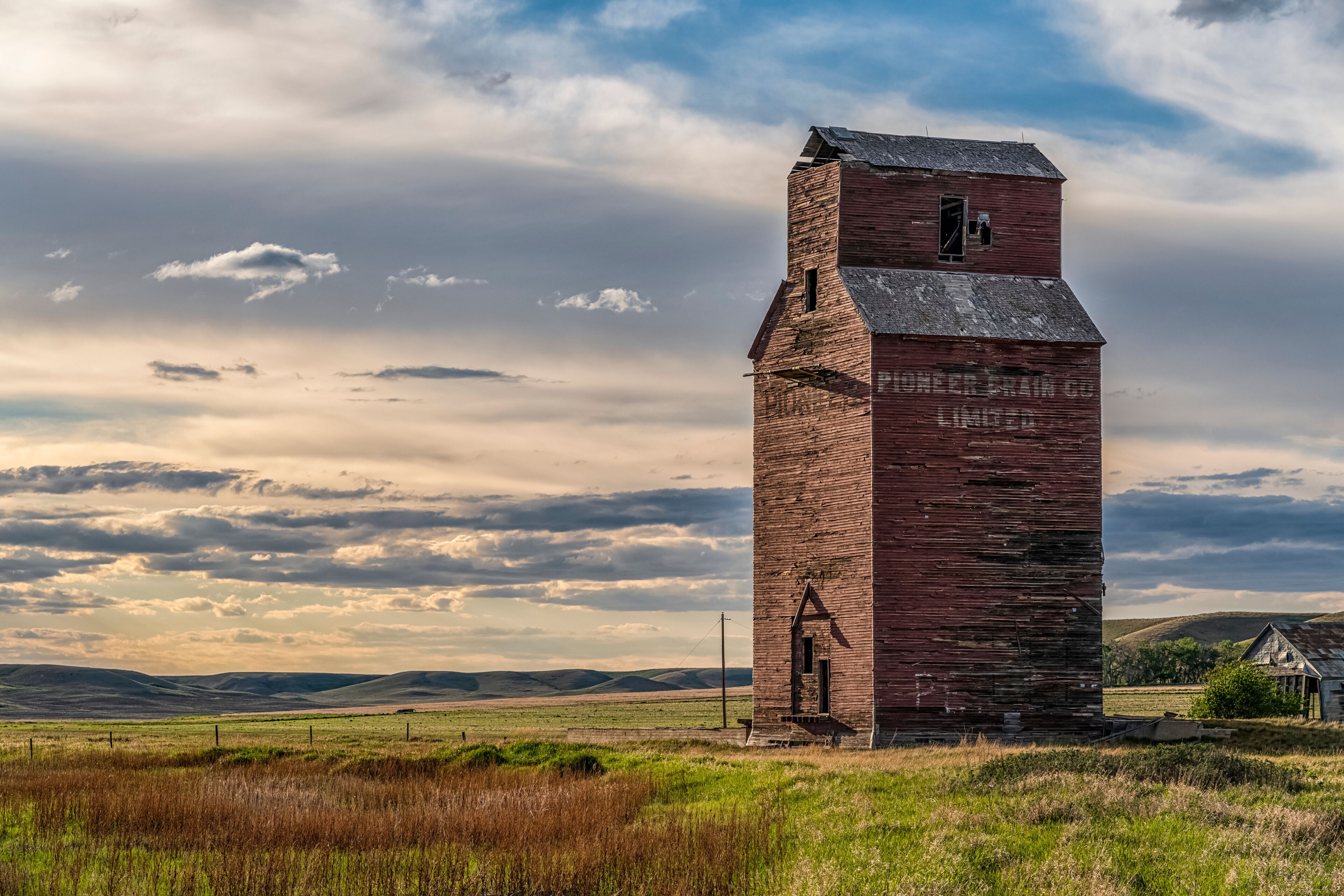 Abandoned and weathered grain elevator at sunset on the Canadian Prairies; Swift Current, Saskatchewan, Canada