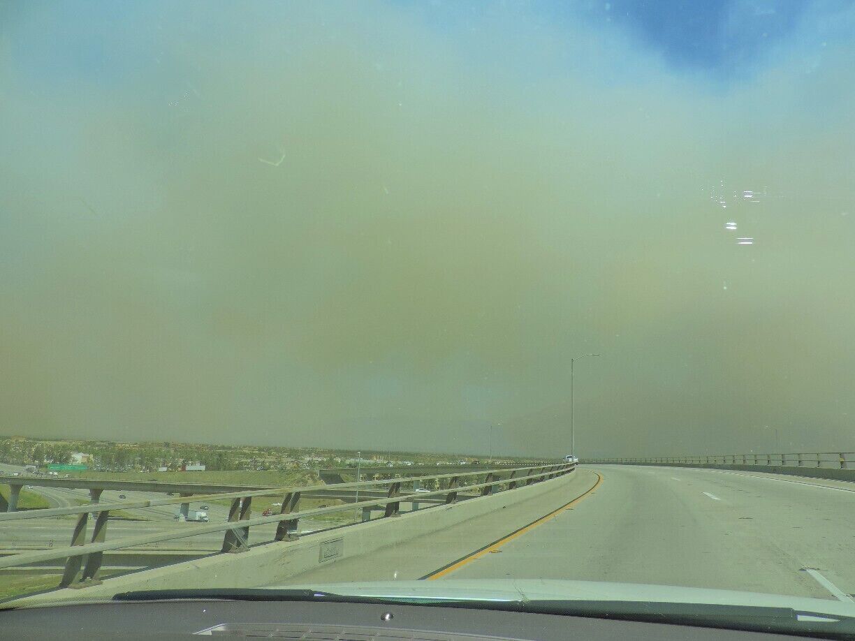 The drought in California combined with a heat wave led to some fires that made it hard to see while driving! You can barely see a glimpse of the bright blue sky through all that smoke.