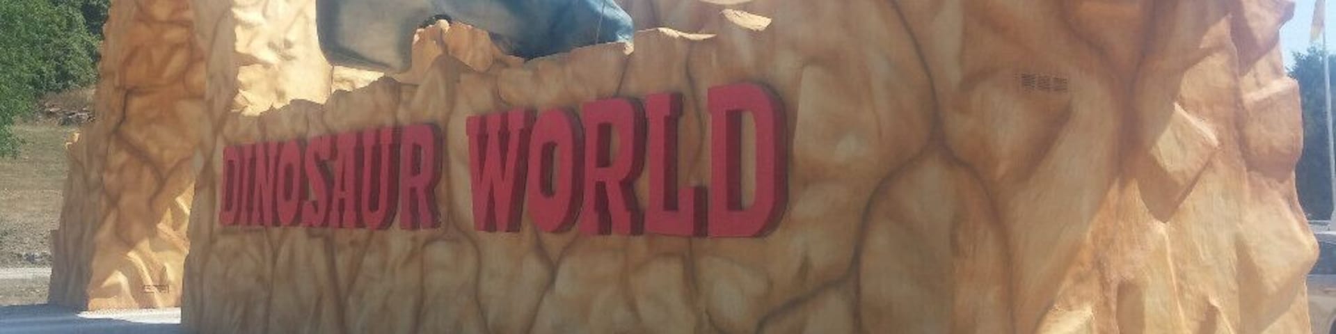 Dinosaur World, if it must be labeled a tourist trap, it's most definitely a high end tourist trap with over 150 life size fiberglass dinosaur sculptures spread along a wooded path over 20 acres.