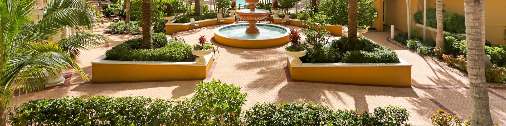 Naples, Florida Luxury Living Community with Large Palm Trees on a Courtyard and a Fountain in the Middle