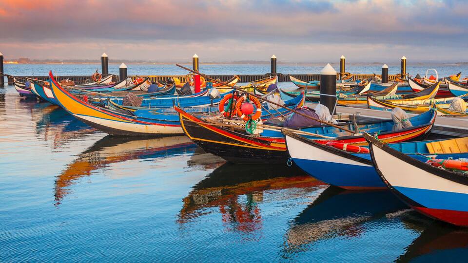 A harbor with colorful boats docked at the pier.