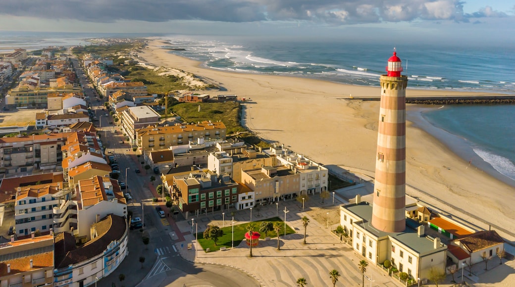 Lighthouse into the Barra beach in Aveiro, Portugal